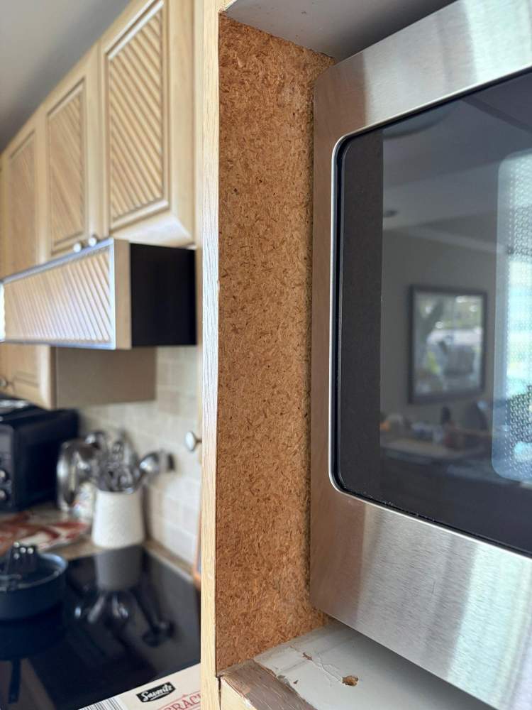 Exposed cabinet side beside microwave